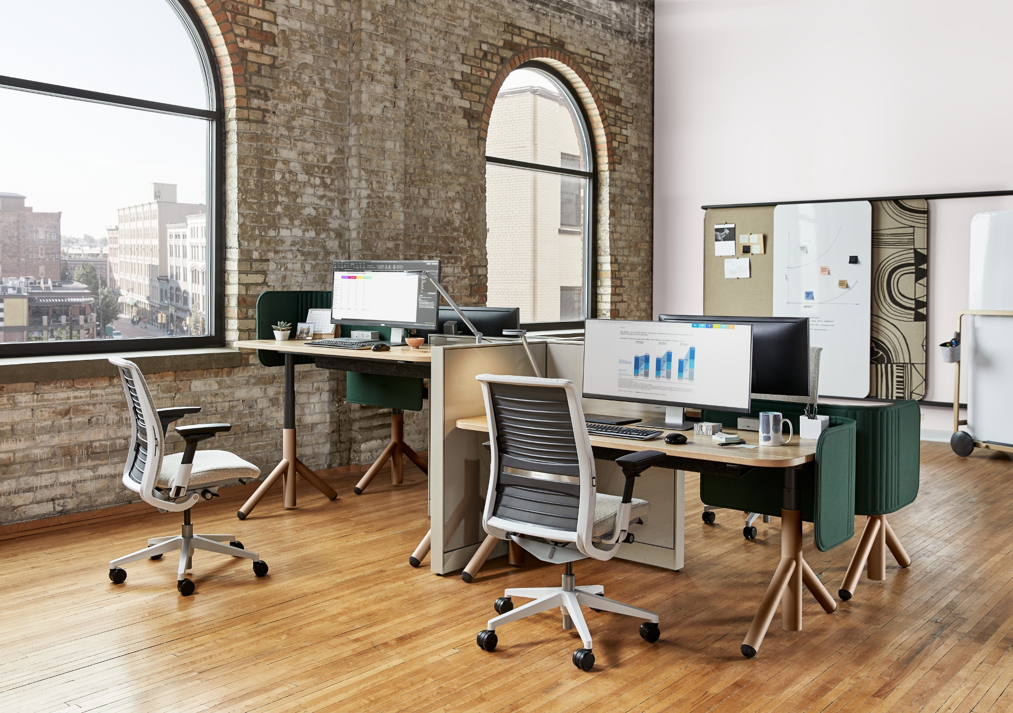 An image that demonstrates the height-adjustable feature of Steelcase work desks.